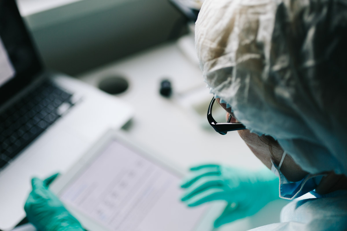 Back view of scientist working on tablet