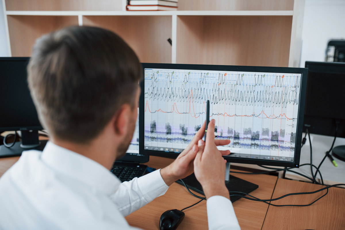 Working process. Polygraph examiner in the office with his lie detector's equipment